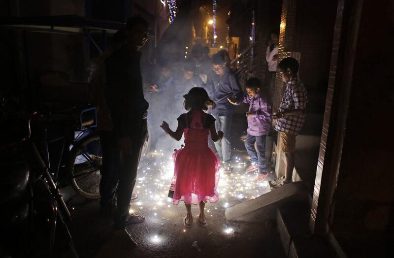 Children stand around watching firecrackers during Diwali celebrations in New Delhi on November 12, 2015. Altaf Qadri / AP