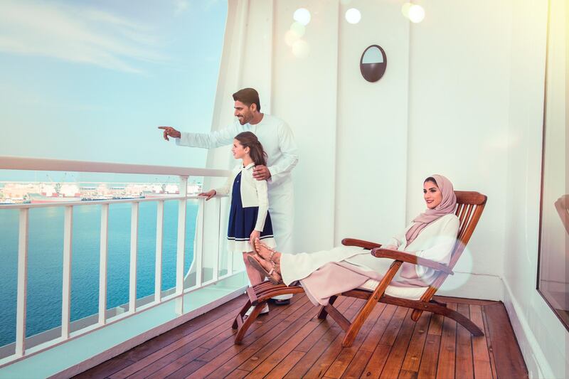 A family enjoys the balcony on the new QE2. PCFC Hotels