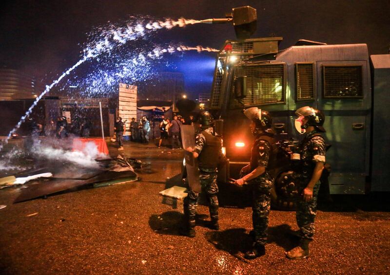 Lebanese security forces fire water cannon amdist clashes during a mass protest at Riad al-Solh Square in the centre of the capital Beirut. AFP