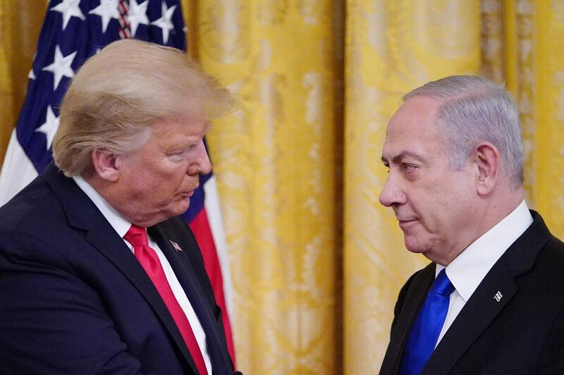 TOPSHOT - US President Donald Trump and Israel's Prime Minister Benjamin Netanyahu take part in an announcement of Trump's Middle East peace plan in the East Room of the White House in Washington, DC on January 28, 2020. Trump declared that Israel was taking a "big step towards peace" as he unveiled a plan aimed at solving the Israeli-Palestinian conflict. "Today, Israel takes a big step towards peace," Trump said, standing alongside Netanyahu as he revealed details of the plan already emphatically rejected by the Palestinians. / AFP / MANDEL NGAN

