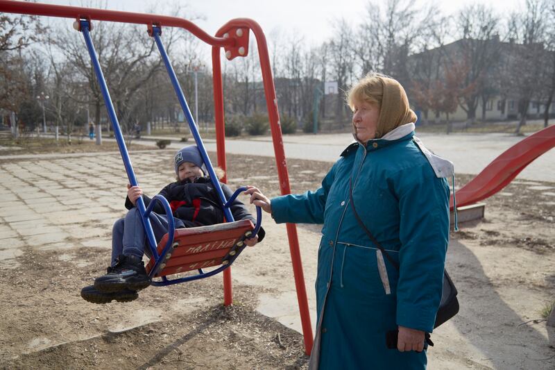 A child on a swing with his grandmother in Prymorsk, Ukraine, as Russian forces conduct large-scale military exercises in Belarus, across the border. Getty Images