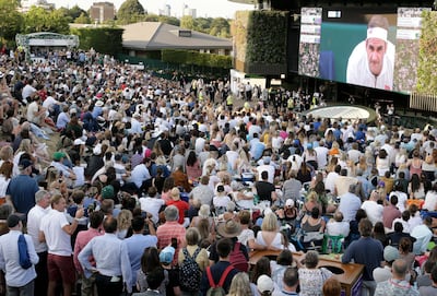 FILE - In this Friday, July 12, 2019 file photo, people sitting on Murray mound watch the men's singles semifinal match between Spain's Rafael Nadal and Switzerland's Roger Federer on day eleven of the Wimbledon Tennis Championships in London.  Wimbledon has been canceled for the first time since World War II because of the coronavirus pandemic. The All England Club announced after an emergency meeting that the oldest Grand Slam tournament in tennis would not be held in 2020. (AP Photo/Tim Ireland, File)