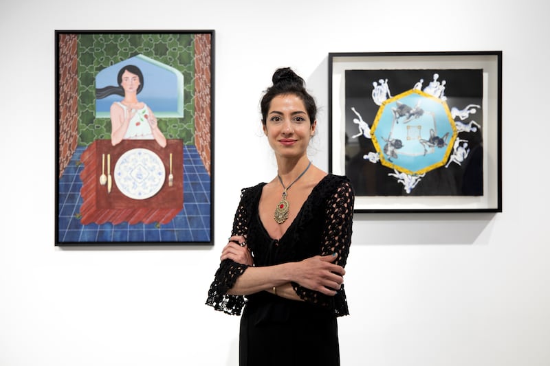 Artist Negin Fallah next to her works.