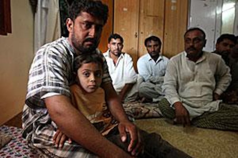 Mukhtiar Ahmed Khudabaksh with his son Mustaffa, 7, and other relatives at home in Dubai.