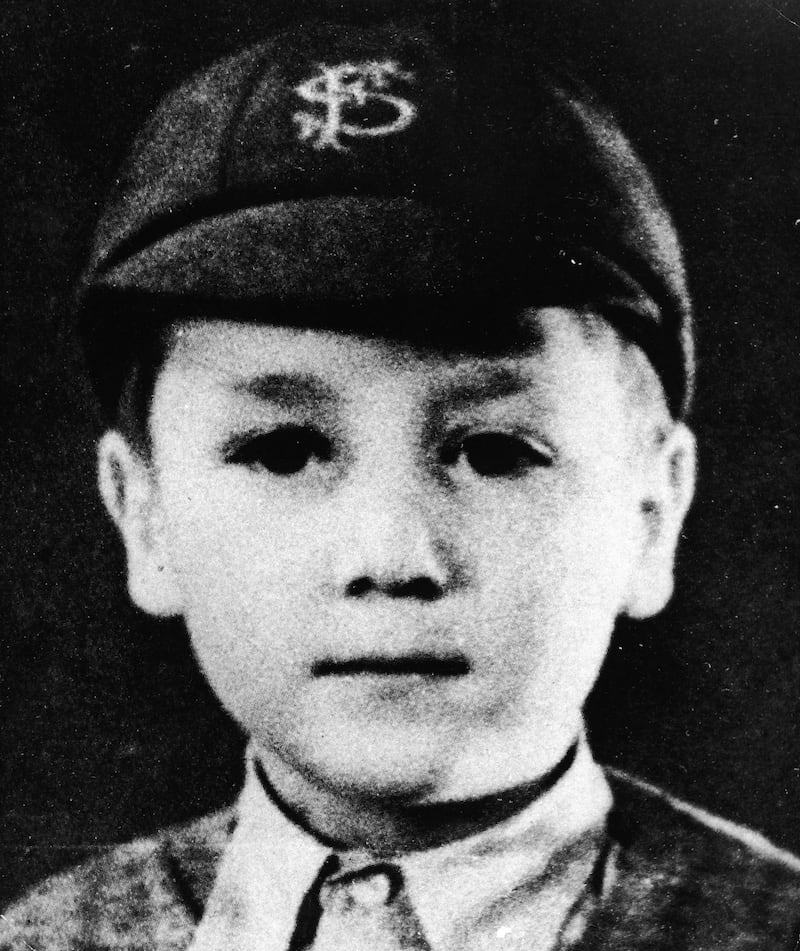 Headshot portrait of British musician and songwriter John Lennon (1940 -1980), of the pop group The Beatles, as a young boy in a school uniform and cap, circa 1948. (Photo by Pictorial Press/Getty Images)