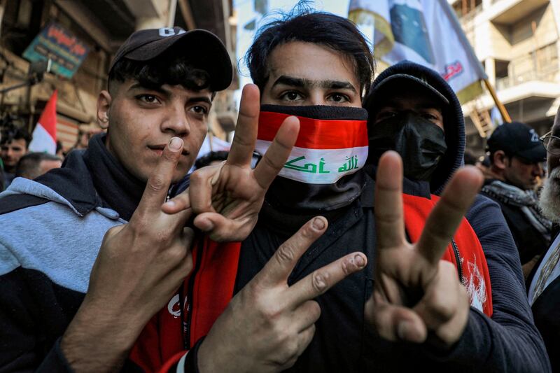 Demonstrators gesture during the protest. The Iraqi dinar's official exchange rate is fixed by the government and remains unchanged at one dollar for 1,470 dinars. AFP