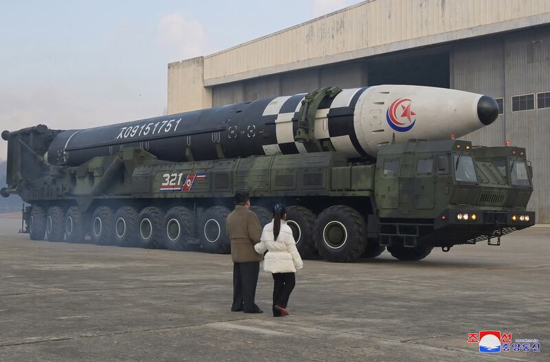 On a visit to Pyongyang International Airport, North Korean leader Kim Jong-un and a girl purported to be his daughter inspect a Hwasongpho-17 ballistic missile. EPA