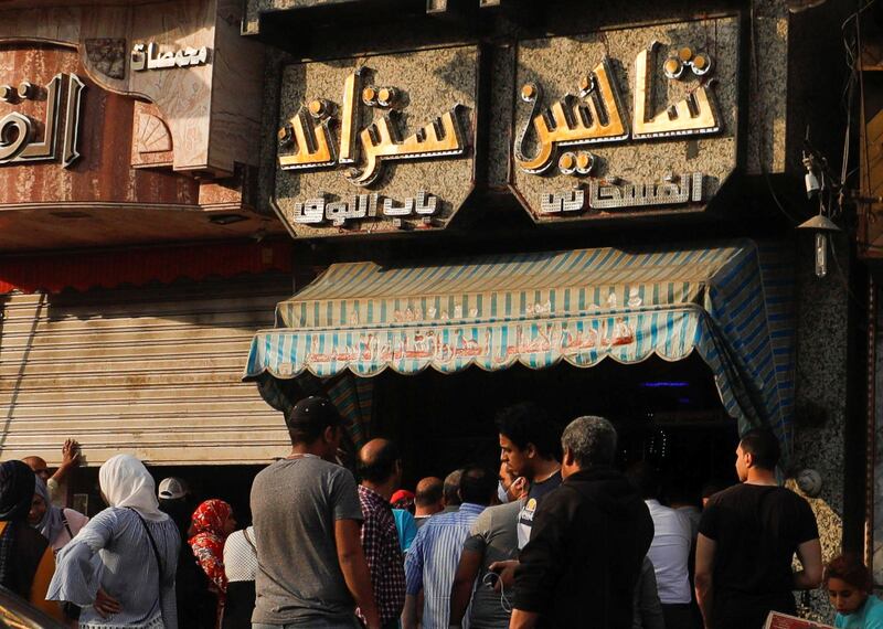Egyptians wait outside Shaheen market for salted fish named "Fesikh", a traditional dish, which is eaten during the Sham El Nessim holiday next week at El Sayeda Zeinab square in old Cairo. Reuters