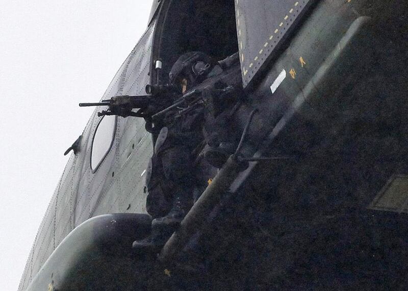 Armed security forces fly overhead in a military helicopter in Dammartin-en-Goele. Thibault Camus / AP Photo