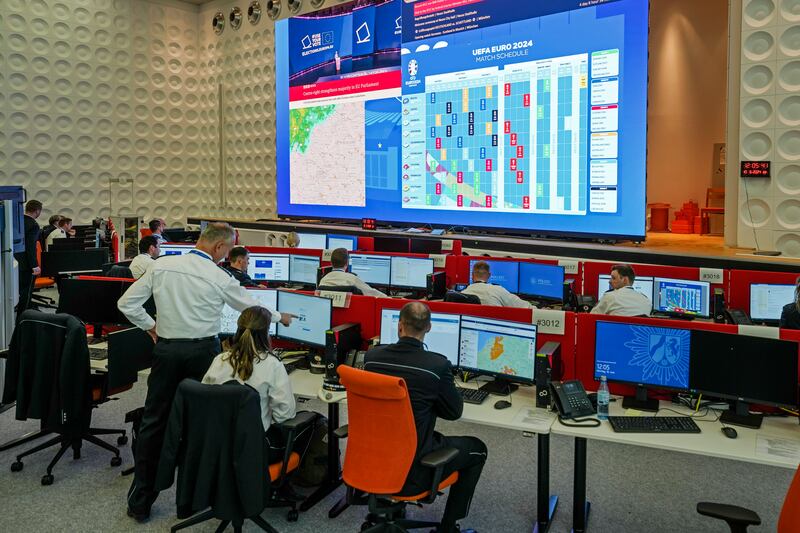 Officers work at the International Police Co-operation Centre in Neuss. Several hundred police officers from all over Europe will operate from there to monitor security during the football tournament. AP