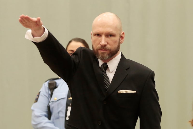 FILE - In this Tuesday, Jan. 10, 2017 file photo, Anders Behring Breivik raises his right hand at the start of his appeal case in Borgarting Court of Appeal at Telemark prison in Skien, Norway, Tuesday, Jan. 10, 2017. The manifesto that the presumed New Zealand shooter who killed at least 49 people in two mosques in Christchurch on Friday, March 15, 2019 published is shorter and "more sloppy" than the one written by a Norwegian right-wing extremist who killed 77 people in 2011, but expresses similar sentiments, a Swedish terror expert said.  (Lise Aaserud/NTB Scanpix via AP, File)