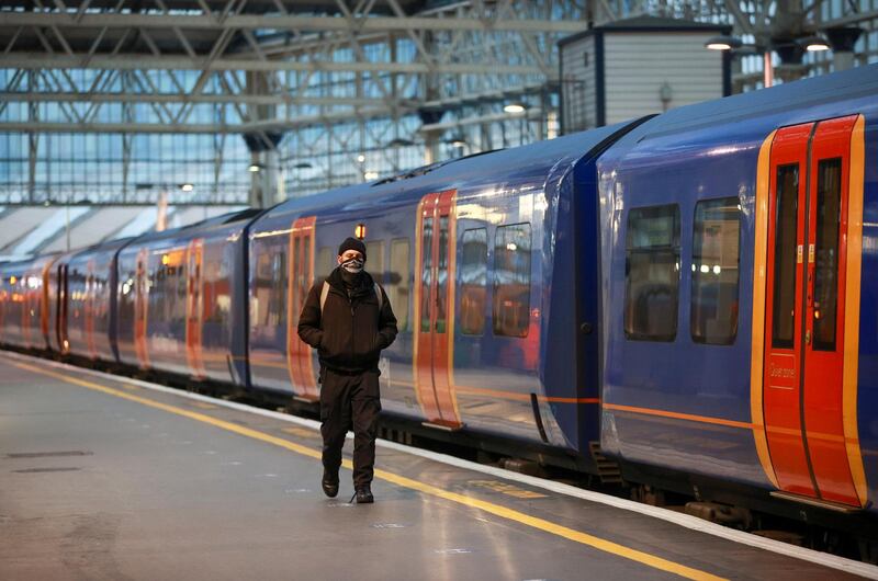 A man walks next to a train at Waterloo station during morning rush hour on Tuesday morning in London. Reuters