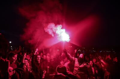 Protesters light flares near the National Assembly in Paris after the government pushed through its pension reforms without a vote on March 16. EPA