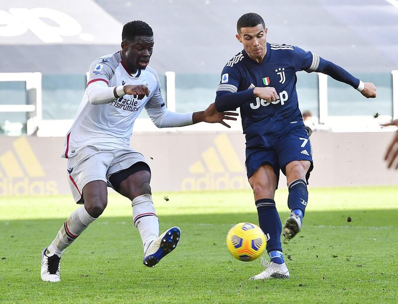 Juve's Cristiano Ronaldo shoots at goal under pressure from Musa Barrow of Bologna at the Allianz Stadium in Turin. EPA