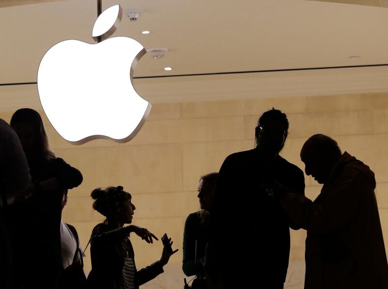 In this May 31, 2018, photo, customers enter the Apple store in New York. Apple serves up fiscal third-quarter results Tuesday, July 31. The iPhone maker is expected to extend its string of solid earnings and revenue growth with its latest quarterly report card. (AP Photo/Mark Lennihan)