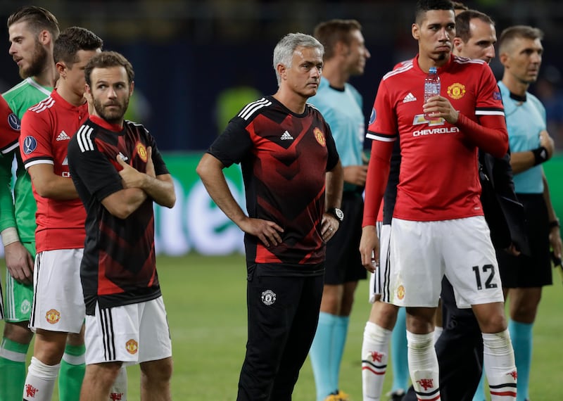 Manchester United's coach Jose Mourinho stands with some of his players after the Super Cup final soccer match between Real Madrid and Manchester United at Philip II Arena in Skopje, Tuesday, Aug. 8, 2017. Real Madrid defeated Manchester United 2-1. (AP Photo/Thanassis Stavrakis)