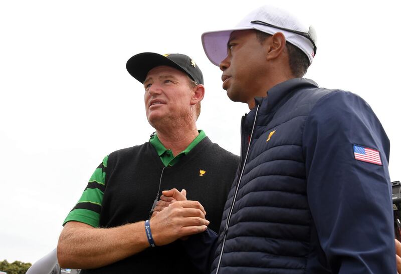 International team captain Ernie Els, left, shakes hands with US team player and captain Tiger Woods. AP