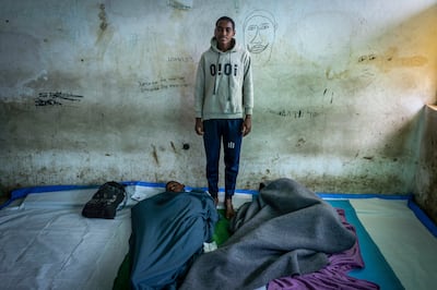 Mulu Adugna, 18 years old, poses for a photo in the room where he sleeps at a center for the internally-displaced in Debark, in the Amhara region of northern Ethiopia Friday, Aug.  27, 2021. AP