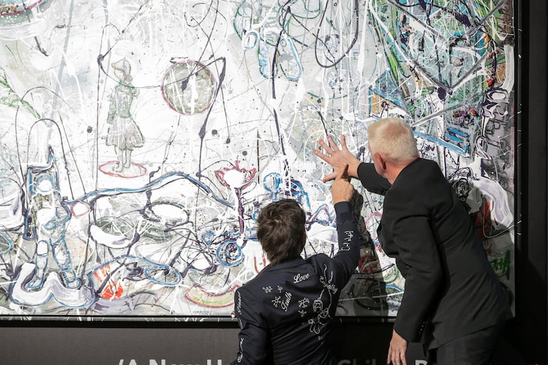 Artista Sacha Jafri and Boris Becker places a finishing hand print on one of his art works during the auction. Art on auction at the 100 Million Meals charity auction at the Mandarin Oriental Jumeirah in Dubai on April 24 th, 2021. 
Antonie Robertson / The National.
Reporter: Rory Reynold for National