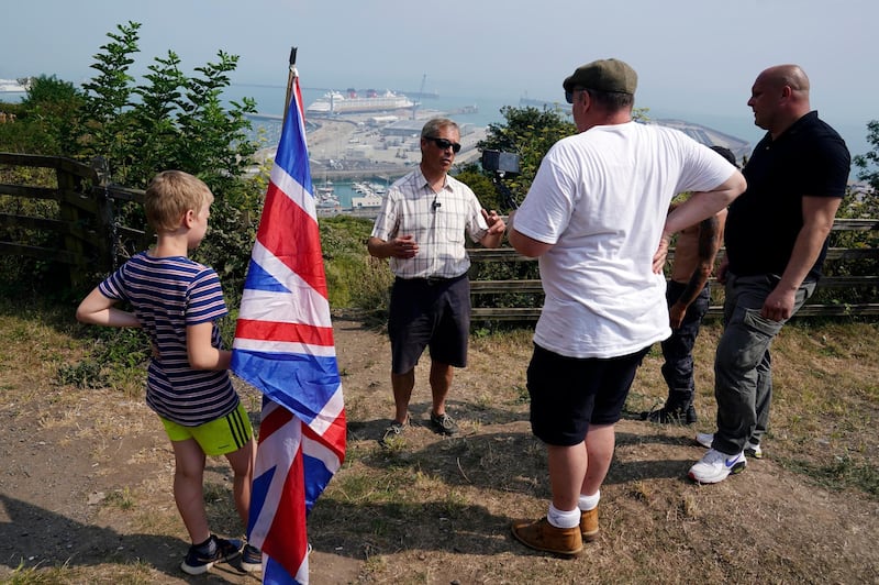 Brexit Party leader Nigel Farage (2nd left) talks to supporters in Dover. EPA