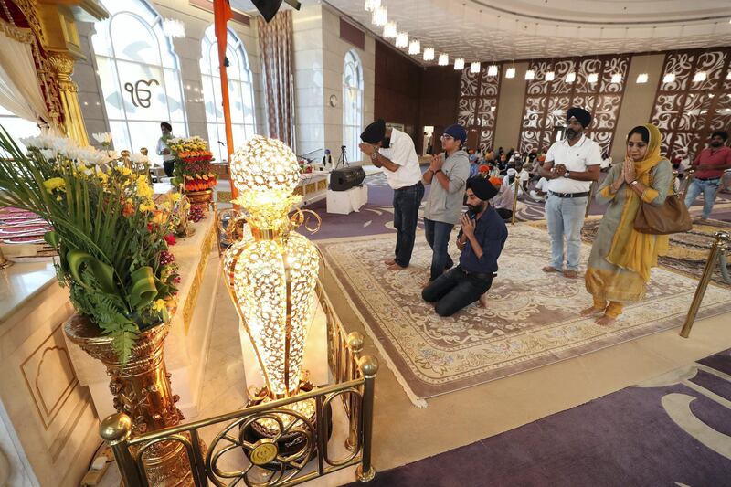 Dubai, United Arab Emirates - May 15, 2019: Members of the congregation pray. People take part in a multi faith Iftar at Gurunanak Darbar Sikh Gurudwara. Wednesday the 15th of May 2019. Jebel Ali, Dubai. Chris Whiteoak / The National