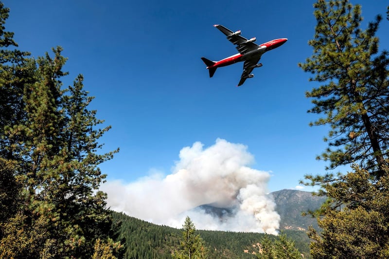 An aircraft prepares to drop fire retardant while battling a blaze in the Mendocino National Forest, California. AP