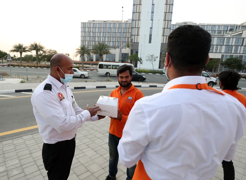 People receive the packages in Dubai South. Chris Whiteoak / The National