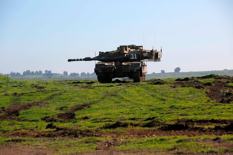 An Israeli tank holds position near Moshav Kidmat Tzvi in the Israeli-annexed Golan Heights on December 25, 2020. Israeli missile strikes on Syria killed at least six Iran-backed fighters on December 25. The dead were all foreign paramilitaries fighting alongside President Bashar al-Assad's forces, the Syrian Observatory for Human Right said. / AFP / JALAA MAREY
