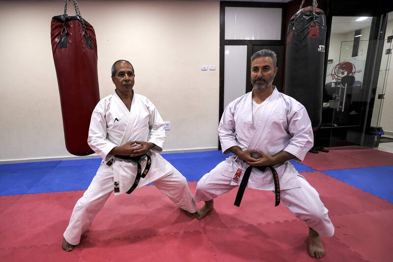 Black-belt karate instructors strike a pose.