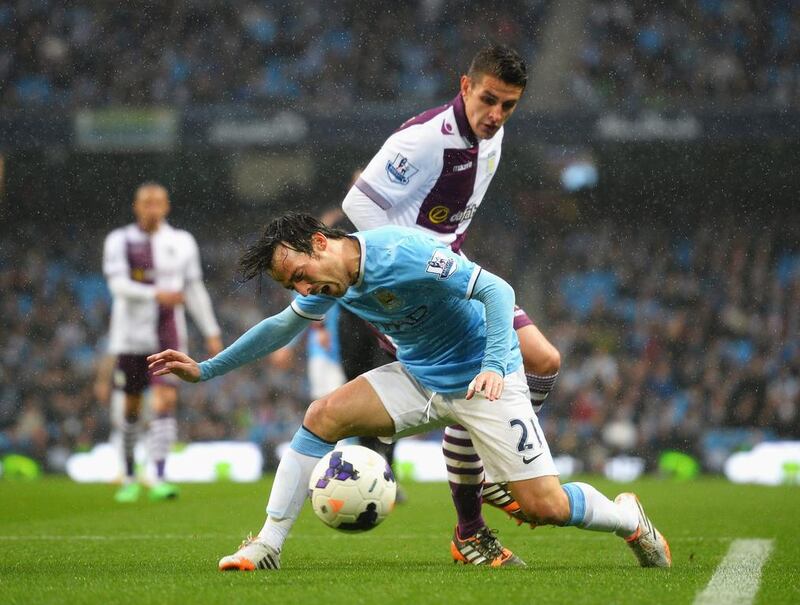 David Silva of Manchester City goes to ground after a challenge by Ashley Westwood of Aston Villa on Wednesday. Laurence Griffiths / Getty Images / May 7, 2014