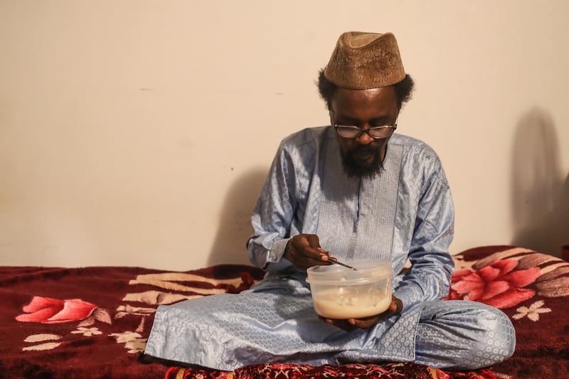 A man eats his suhoor meal in preparation for the first day of Ramadan.  EPA