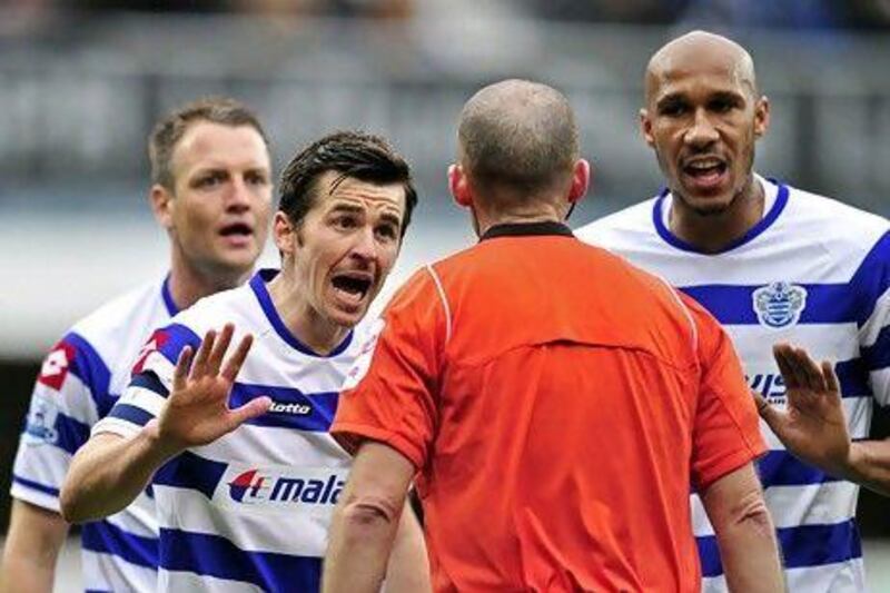 Queens Park Rangers' English midfielder Joey Barton (L) argues with referee Mike Dean. The 'bad boy; of English football is now off to France.