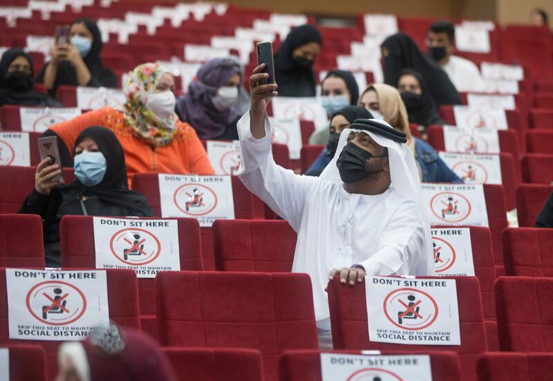 Ajman, United Arab Emirates - Proud parents of the graduates documenting the event at the Al Shola American School first in-person graduation for 12 graders.  Leslie Pableo for The National for Amir's story