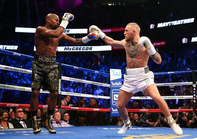 Conor McGregor moves in against Floyd Mayweather in the first round at T-Mobile Arena. USA TODAY Sports