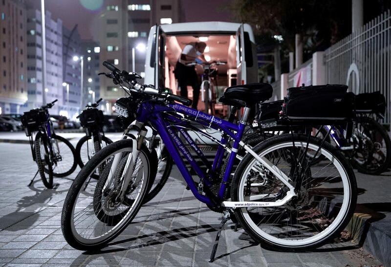 Abu Dhabi, United Arab Emirates, May 11, 2020.   Abu Dhabi Police bicycle patrol do night operations around the Mussaffah area to warn or catch curfew violators in the residential areas. --  A bike patrol officer unloads the police bikes from a custom made bus with special doors and a hydraulic mini lift for easy access.
Victor Besa / The National
Section:  NA
Reporter:  Haneen Dajani