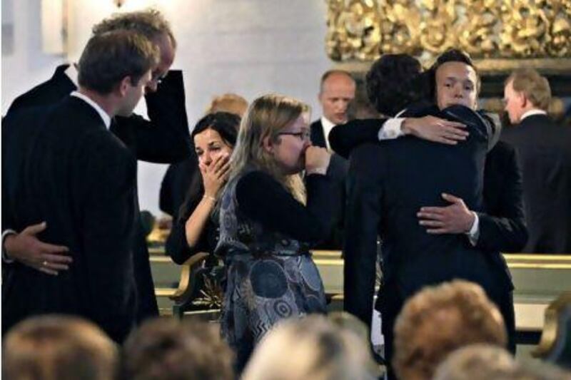 Mourners embrace during a memorial service yesterday at Oslo Cathedral in the aftermath of the attacks on Norway's government headquarters and a Labour Party youth retreat.