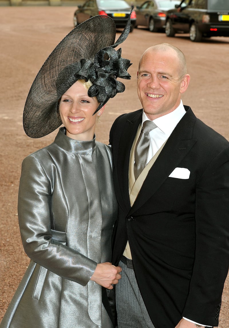 Zara Phillips, wearing a silver coat dress and dark grey head piece, and Mike Tindall leave the wedding reception for the Duke and Duchess of Cambridge at Buckingham Palace on April 29, 2011. Getty Images 