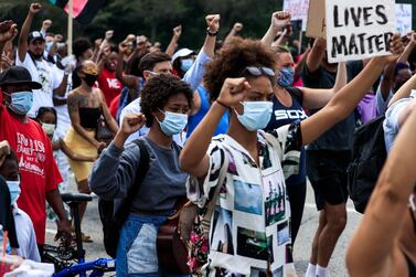 People walk with raised fists as they participate in a Juneteenth rally in Chicago. EPA