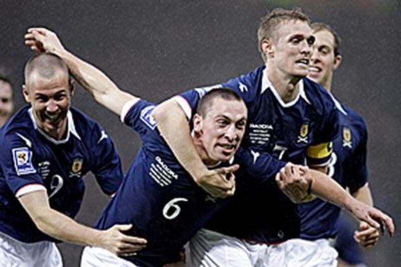 Scotland's Scott Brown, centre, celebrates his goal against Macedonia with teammates Kenny Miller, left, and Darren Fletcher.