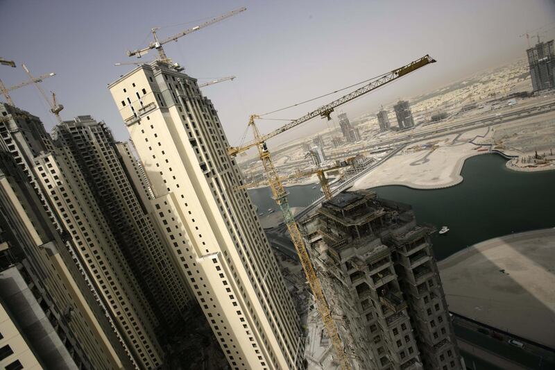 DUBAI, UNITED ARAB EMIRATES - MAY 01: A view over part of the massive construction of exclusive new developments in the Dubai Marina area on May 1, 2006 in Dubai, United Arab Emirates. Apartments rent out here often at a minimum of $2000 a day. Dubai is second only to Shanghai at this time in terms of the scale of construction work in the area. The construction work is being done by migrant labour who make up over 2 thirds of Dubai's population. Migrant labourers in Dubai live in labour camps which are often over 2 hours away. The workers generally work a 12 hour shift. The majority of labourers come to Dubai from India, Pakistan and Bangladesh. These workers operate in extreme temperatures in the desert climate, the majority earning under $200 a month. Many have to spend a third of that sum on food provided at the camps as part of their contract. Most sign recruitment contracts in their own countries which take them into debt for many years. Their passports are held by their employers once they reach the UAE and if the company owners abscond the workers are often abandoned without their documents or due payment. Over two thirds of the Dubai population is migrant labour with 1.1 million working in construction. Dubai is currently second only to Shanghai in terms of the scale of construction underway on a 24 hour basis. All this is woefully underscrutinised by the Ministry of Labour, there are currently only 80 government inspectors for over 200 000 construction companies. Recently there have been rumblings of discontent from the workers, with strikes at numerous sites over the non-payment of wages and harsh working conditions. In 2005, according to Human Rights Watch, there were 84 suicides by construction workers in Dubai. (Photo by Brent Stirton/Getty Images)  *** Local Caption ***