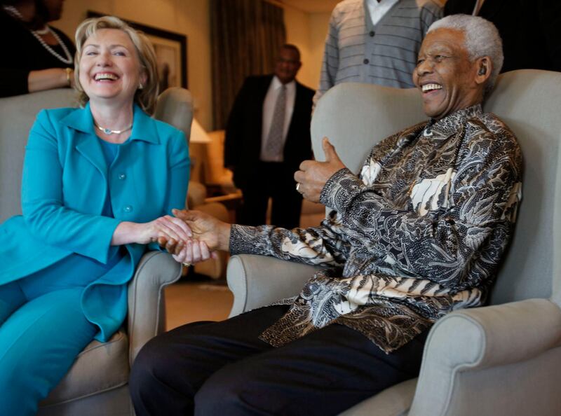 U.S. Secretary of State Hillary Clinton (L) smiles as she is welcomed by Former South African President Nelson Mandela during a courtesy call at the Nelson Mandela foundation in Johannesburg, August 7, 2009. Clinton earlier in Pretoria encouraged South Africa on Friday to use its clout to bolster reforms in Zimbabwe and said closer ties would be built with Pretoria after strains under the Bush administration. REUTERS/ Denis Farrell/ Pool  (SOUTH AFRICA IMAGES OF THE DAY POLITICS) *** Local Caption ***  SSIB08_SAFRICA-CLIN_0807_11.JPG