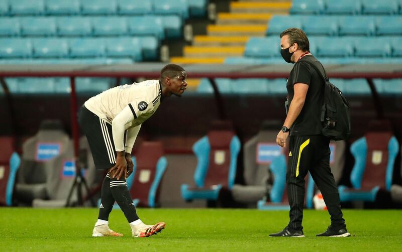 Manchester United's Paul Pogba, left, stretches after going down late in the game don Thursday. PA
