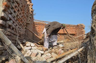 A assesses his damaged house in a flood-hit area of Pakistan. AFP