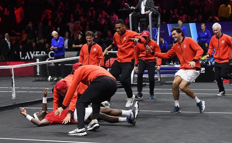 Team World run on to the court to congratulate Francis Tiafoe after he beat Team Europe's Stefanos Tsitsipas to win the Laver Cup at the O2 Arena in London, on September 25, 2022. EPA