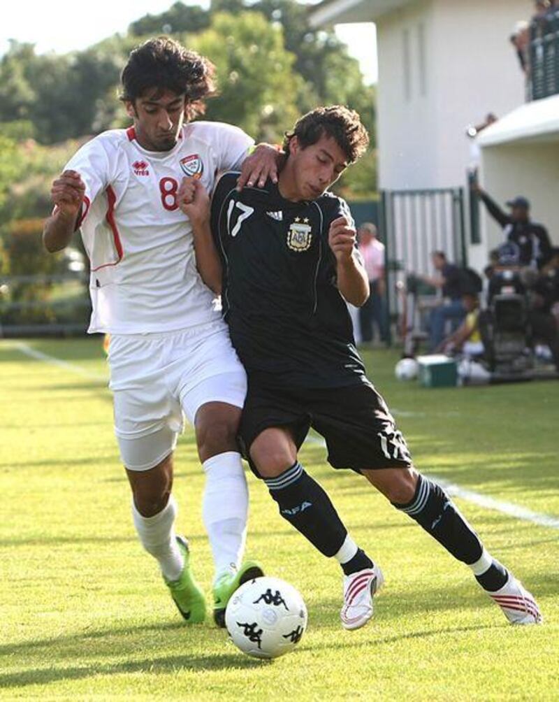 Hamdan al Kamali, left, seen here challenging Argentina U21's midfielder Lucas Trecarichi,  may get the chance to play for the UAE against Argentina's senior side if the FA secure the prestige friendly they hope for.