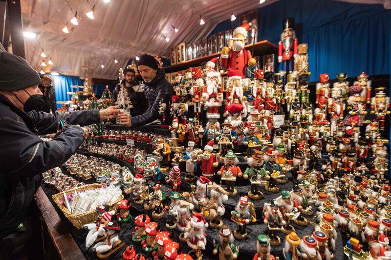 A man buys small Christmas-themed figurines in Frankfurt. AFP