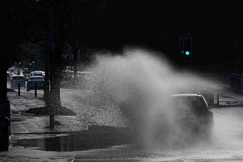 Cars drive through floodwater as hurricane-force winds and rain affected the country's transport network leading to disruptions and prompting warnings of power cuts and a risk to life, in Manchester, Britain. REUTERS