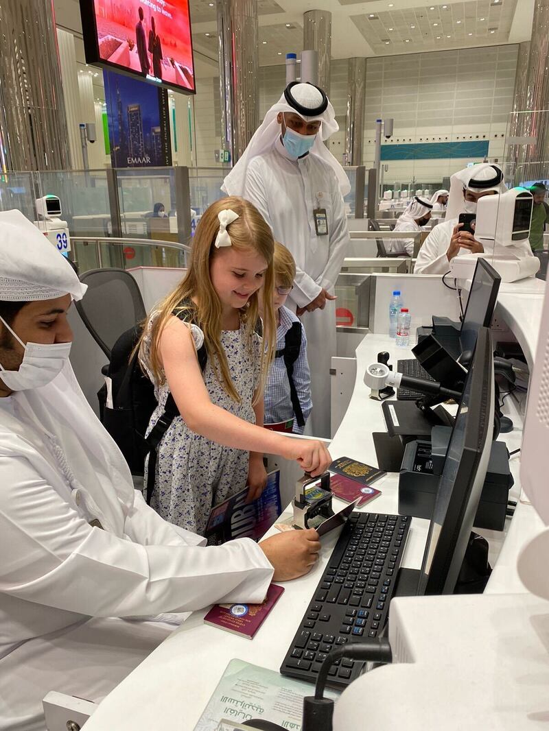 Isobel, 9, stamps her passport at Dubai International Airport. All photos: GDFRA