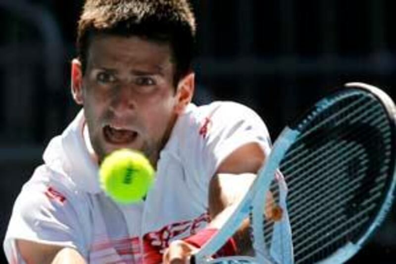 Serbia's Novak Djokovic returns a shot against Lukasz Kubot of Poland during the Australian Open tennis tournament in Melbourne January 25, 2010.   REUTERS/Mick Tsikas (AUSTRALIA - Tags: SPORT TENNIS) *** Local Caption ***  OZ043_TENNIS-OPEN-_0125_11.JPG