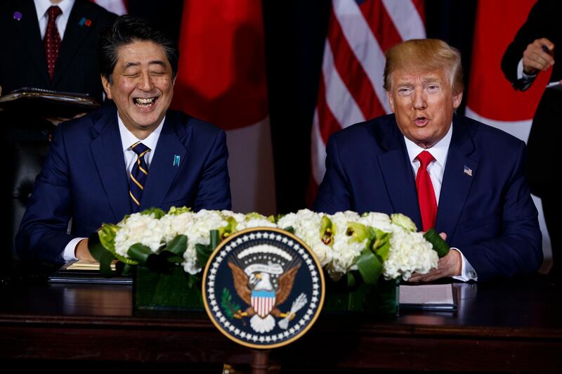 Japanese Prime Minister Shinzo Abe laughs as President Donald Trump speaks before signing an agreement on trade at the InterContinental Barclay New York hotel during the United Nations General Assembly in New York. AP Photo